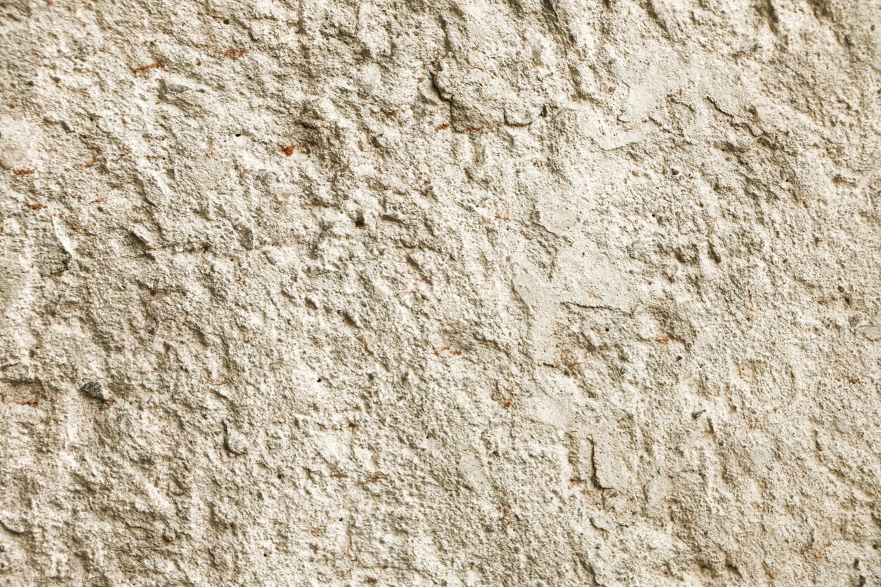 Close-up texture of a rough stone wall surface in natural light.